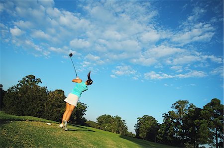 Young Woman Hitting Driver Shot from Golf Tee Stock Photo - Premium Royalty-Free, Code: 622-05786882