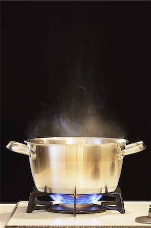 Lit Gas Stove With Pot Stock Photo - Premium Royalty-Free, Code: 622-06163815