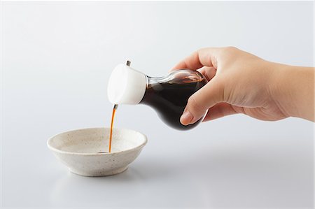 Human Hand Pouring Oil In Bowl Stock Photo - Premium Royalty-Free, Code: 622-06163928