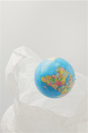 plants growing on planet earth - Globe And Plastic Bag Stock Photo - Premium Royalty-Free, Code: 622-06163950