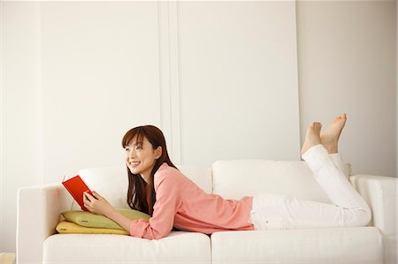 Japanese Woman Lying Down And Holding Book Stock Photo - Premium Royalty-Free, Code: 622-06190765