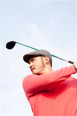 Portrait Of Golfer Swinging Foto de stock - Sin royalties Premium, Código: 622-06191066