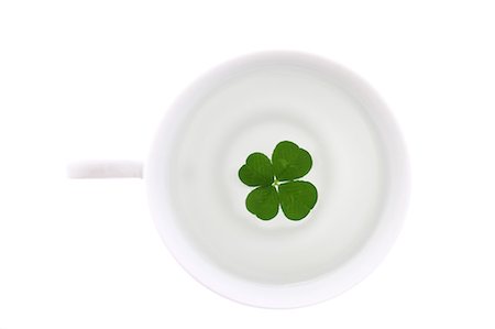 simsearch:622-06191161,k - Four Leaf Clover In Coffee Cup Foto de stock - Sin royalties Premium, Código: 622-06191203