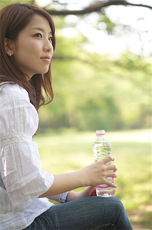 Woman sitting on a bench Stock Photo - Premium Royalty-Free, Code: 622-06370289