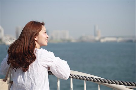 Woman looking at the sea Stock Photo - Premium Royalty-Free, Code: 622-06370299