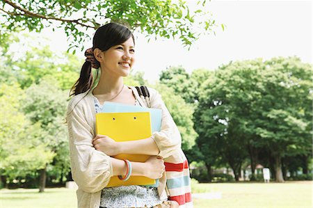 Female college student in a park smiling away Stock Photo - Premium Royalty-Free, Code: 622-06900451