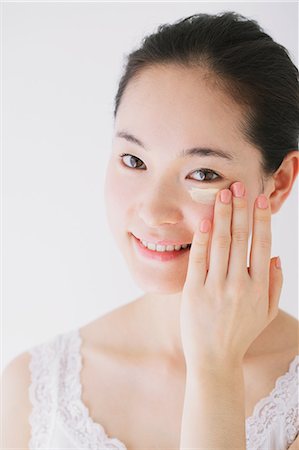 simsearch:622-06964281,k - Young woman putting foundation cream Stock Photo - Premium Royalty-Free, Code: 622-06964266