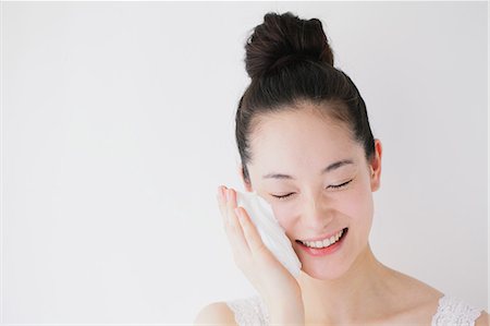 Young woman putting face-wash foam Stock Photo - Premium Royalty-Free, Code: 622-06964277