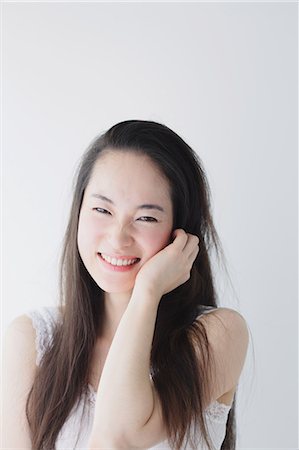 simsearch:622-06964290,k - Young woman with long hair smiling Stock Photo - Premium Royalty-Free, Code: 622-06964297