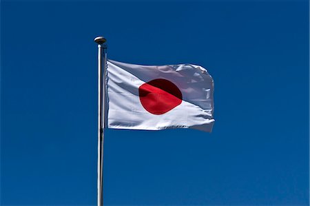 Japanese flag fluttering in the wind Fotografie stock - Premium Royalty-Free, Codice: 622-07108982