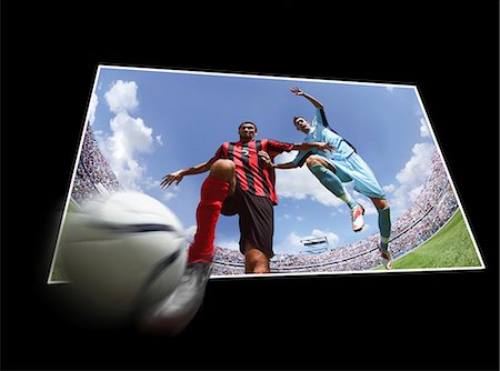 footballer kicking a ball - Football players running with ball Stock Photo - Premium Royalty-Free, Code: 622-07736014