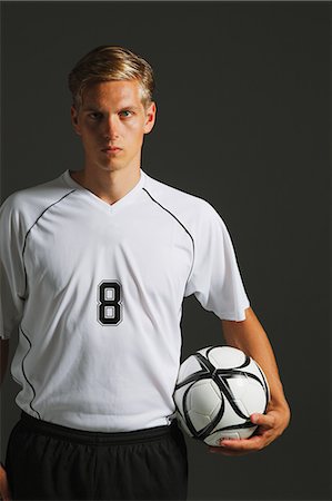 soccer player holding ball - Soccer Player Standing With Ball Stock Photo - Premium Royalty-Free, Code: 622-07736098