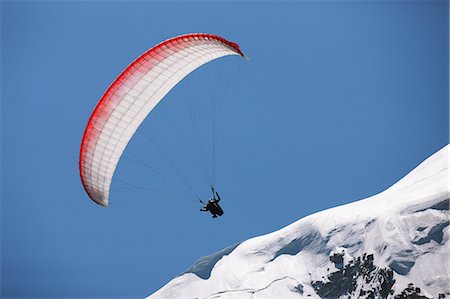 paragliding extreme sport - Paraglider Flying Stock Photo - Premium Royalty-Free, Code: 622-07736101