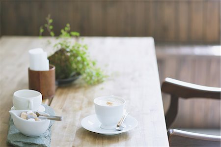 restaurant table not person not outdoors - Cappuccino on wooden table in a cafe Stock Photo - Premium Royalty-Free, Code: 622-07743554