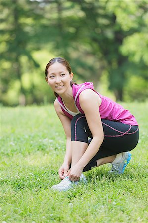 simsearch:622-07760681,k - Young Japanese girl stretching in the park Stock Photo - Premium Royalty-Free, Code: 622-07760596