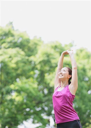 Young Japanese girl stretching in the park Stock Photo - Premium Royalty-Free, Code: 622-07760591