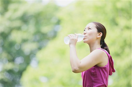 exercise drinking water - Young Japanese girl with water bottle after training in the park Stock Photo - Premium Royalty-Free, Code: 622-07760600