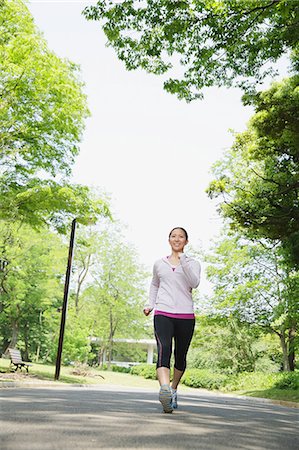 Young Japanese girl walking in the park Stock Photo - Premium Royalty-Free, Code: 622-07760601