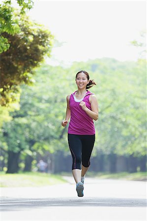 Young Japanese girl running in the park Stock Photo - Premium Royalty-Free, Code: 622-07760603