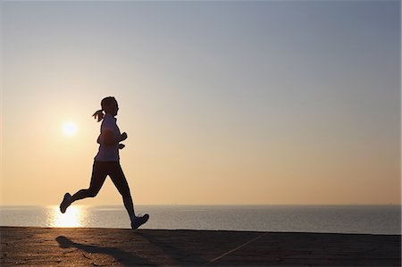 sunsets with trains - Young Japanese girl jogging Stock Photo - Premium Royalty-Free, Code: 622-07760682