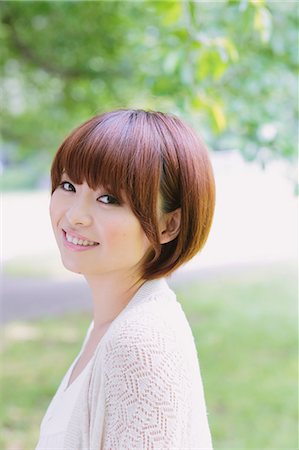 Portrait of young Japanese woman in a park Stock Photo - Premium Royalty-Free, Code: 622-07810771