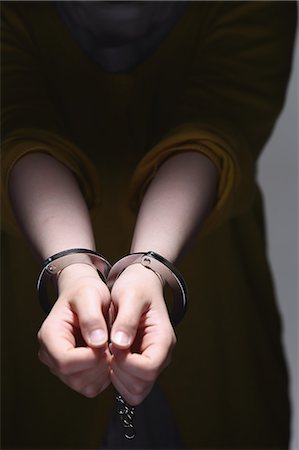 Handcuffed arms Stock Photo - Premium Royalty-Free, Code: 622-08007325