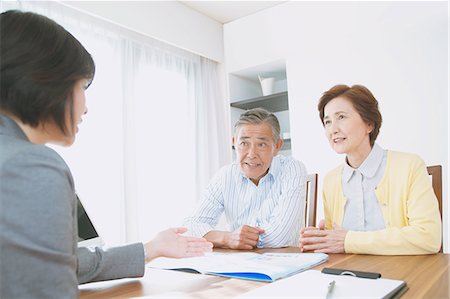 people dining at home images - Senior Japanese couple consulting with financial planner Stock Photo - Premium Royalty-Free, Code: 622-08122705