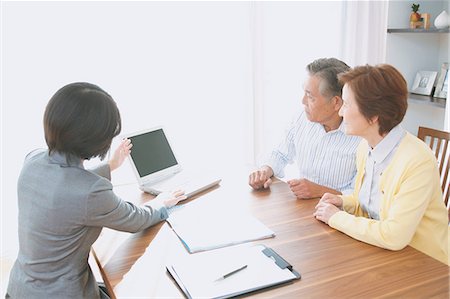 people dining at home images - Senior Japanese couple consulting with financial planner Stock Photo - Premium Royalty-Free, Code: 622-08122707