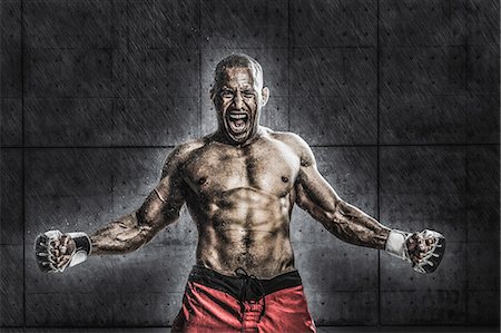 person spreading arms - Bald male athlete in a fighting pose Stock Photo - Premium Royalty-Free, Code: 622-08122804