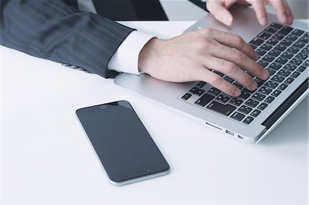 phone screen hands - Japanese businessman working with laptop Stock Photo - Premium Royalty-Free, Code: 622-08122884