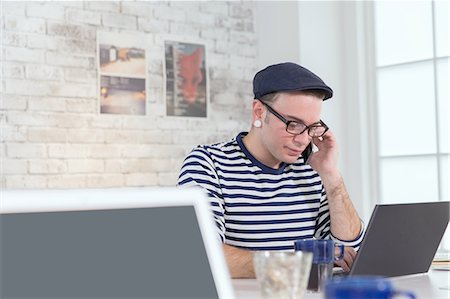 startups - Caucasian man working in modern office Stock Photo - Premium Royalty-Free, Code: 622-08122997