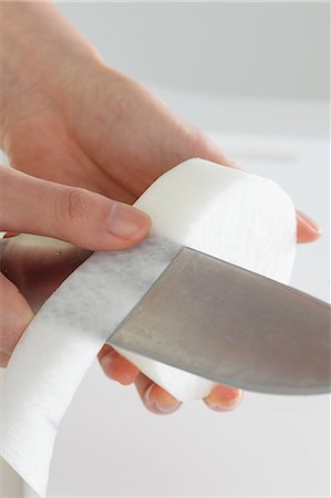 simsearch:859-06538005,k - Close up of woman's hands peeling radish with a kitchen knife Stock Photo - Premium Royalty-Free, Code: 622-08138917