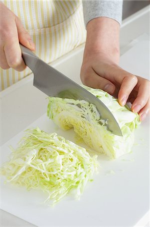 simsearch:859-06537987,k - Close up of woman's hands cutting cabbage with a kitchen knife Stock Photo - Premium Royalty-Free, Code: 622-08138924