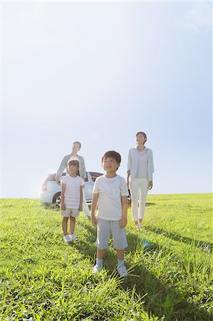 Happy Japanese family with car in a city park Stock Photo - Premium Royalty-Free, Code: 622-08138969