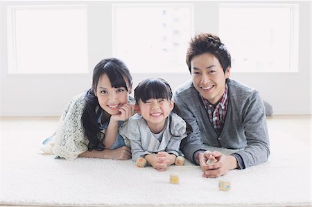 simsearch:622-08122783,k - Young family laying on the floor Stock Photo - Premium Royalty-Free, Code: 622-08139009