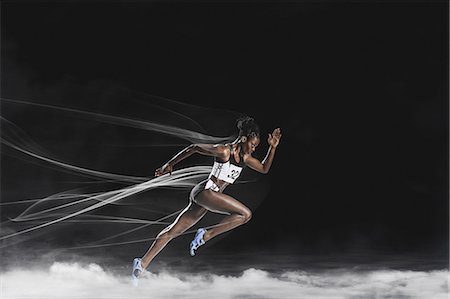 Athlete running in the smoke Stock Photo - Premium Royalty-Free, Code: 622-08355516