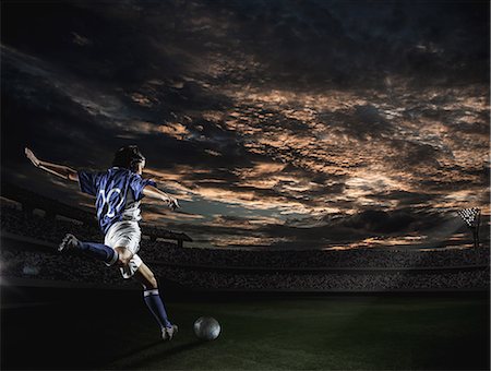 stadium bleachers - Soccer player in dramatic action Stock Photo - Premium Royalty-Free, Code: 622-08355510