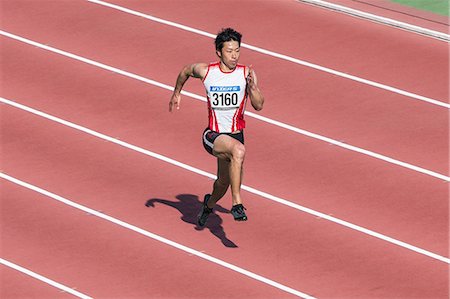 simsearch:622-08355542,k - Japanese male sprinter running on track Fotografie stock - Premium Royalty-Free, Codice: 622-08355536