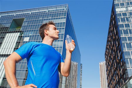 simsearch:622-08355619,k - Young Caucasian man drinking water in metropolitan area Stock Photo - Premium Royalty-Free, Code: 622-08355618