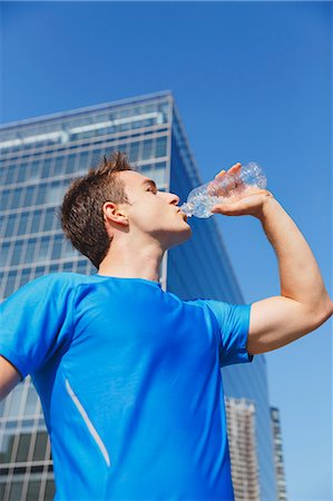 Young Caucasian man drinking water in metropolitan area Stock Photo - Premium Royalty-Free, Code: 622-08355622