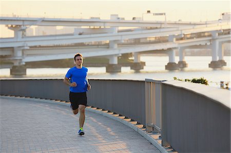 Young Caucasian man running in metropolitan area Stock Photo - Premium Royalty-Free, Code: 622-08355642