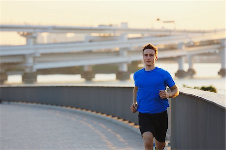 Young Caucasian man running in metropolitan area Stock Photo - Premium Royalty-Free, Code: 622-08355643