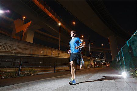 elevated - Young Caucasian man running in metropolitan area Stock Photo - Premium Royalty-Free, Code: 622-08355652