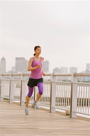 running - Young Japanese woman running downtown Tokyo Stock Photo - Premium Royalty-Free, Code: 622-08355678