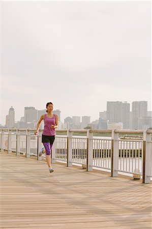 simsearch:622-08355688,k - Young Japanese woman running downtown Tokyo Photographie de stock - Premium Libres de Droits, Code: 622-08355681