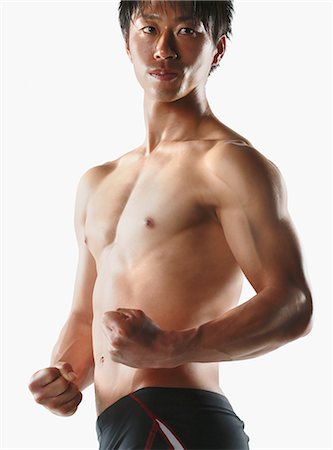Japanese male athlete showing off muscles Stock Photo - Premium Royalty-Free, Code: 622-08355769