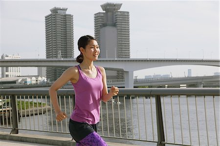 simsearch:622-08355688,k - Young Japanese woman running downtown Tokyo Photographie de stock - Premium Libres de Droits, Code: 622-08355927