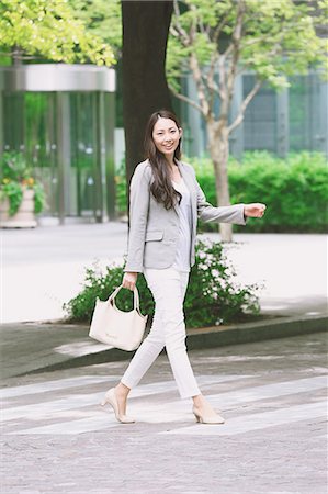 person walking pose full length - Japanese attractive businesswoman in downtown Tokyo Stock Photo - Premium Royalty-Free, Code: 622-08482409