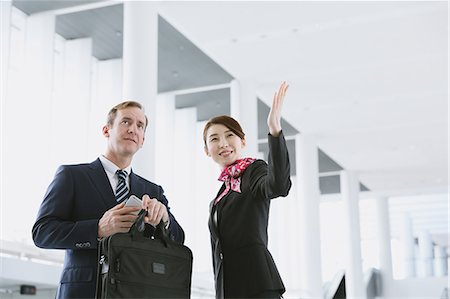 simsearch:622-08482482,k - Japanese attractive flight attendant helping customer at the airport Foto de stock - Sin royalties Premium, Código: 622-08482486