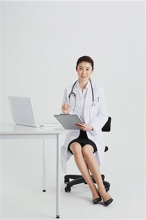 full body people sitting laptop - Attractive Japanese woman doctor Stock Photo - Premium Royalty-Free, Code: 622-08482637